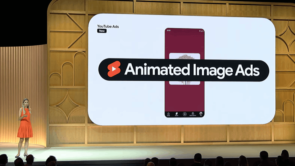 A presenter in an orange dress stands on stage next to a large screen displaying an advertisement for "Animated Image Ads" with a smartphone graphic. The setting appears to be a tech event, perhaps GML 2024, showcasing innovations like YouTube's latest interactive ad formats.