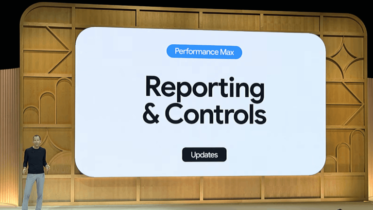 A man stands on a stage with a large screen displaying "Performance Max Reporting & Controls," featuring an "Updates" button. The backdrop of wooden paneling subtly sets the tone for what could be an exciting preview for attendees anticipating GML 2024 developments.