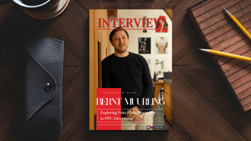 A magazine titled "Interview" features Bernt Muurling smiling in a black shirt. The cover headline delves into fake click prevention strategies in PPC advertising, with items like pencils and a notebook nearby.