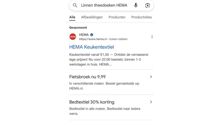 Screenshot of a Google search result for "Linnen theedoeken HEMA" shows Google testing sponsored links for HEMA kitchen textiles, bicycle pants, and bed textiles, with prices and discount offers included in the search results.