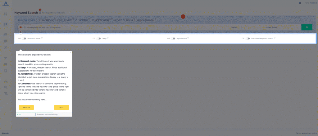 A screenshot of Adzoola's keyword search tool showing search options and a highlighted pop-up help box with instructions. The grey and blue background frames the pop-up, which explains different PPC search modes and includes "PREVIOUS" and "NEXT" buttons.