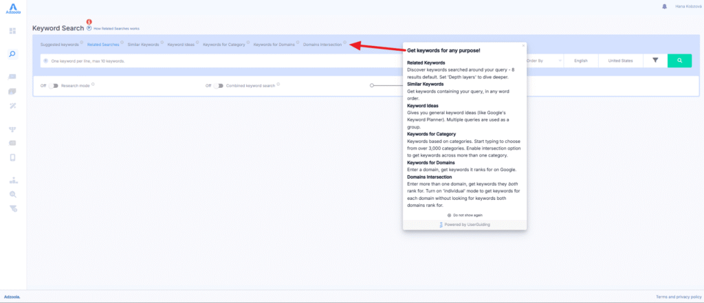 A screenshot of the Adzoola keyword search tool interface with a red arrow pointing to a dropdown menu that explains different keyword search features, such as related keywords—helping you drive results for your PPC campaigns.