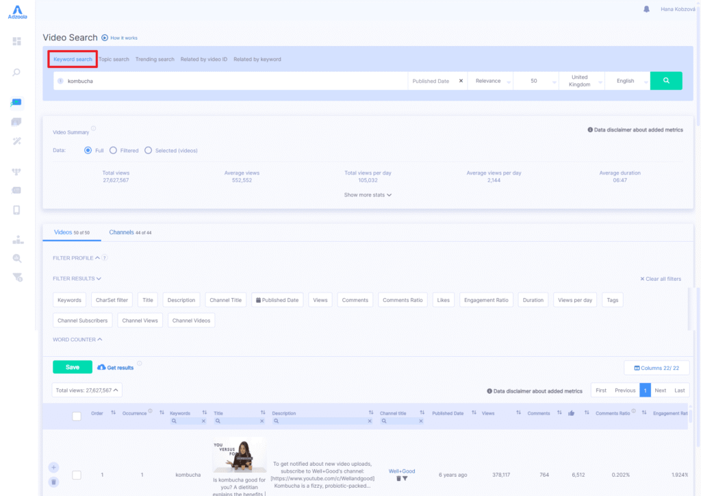 A video search dashboard powered by Adzoola displays results for the keyword "kombucha," featuring filters, data fields, and a detailed video list. The table includes titles, channels, metrics, and prominently shows the first entry’s thumbnail and details.