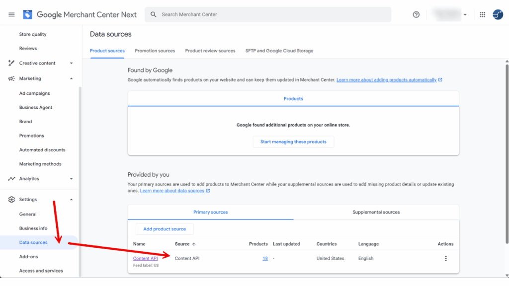Screenshot of the Google Merchant Center Next interface, showing the Data sources page. A red arrow points to "Content API," a Merchant API option under "Primary sources," displaying details like source type, products, and language for Shopping Ads.