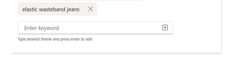Screenshot of a search themes interface showing three keywords: "women's jeans," "comfortable jeans," and "elastic waistband jeans." A text box lets you add more, with the search theme limit increased to 50 in Microsoft PMAX.