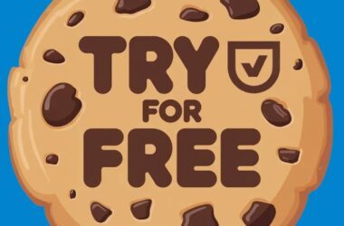 A cartoon chocolate chip cookie with the words "TRY FOR FREE" and a checkmark shield symbol in the center, set against a bright blue background, highlights Cookiebot free trial and key Cookiebot features.