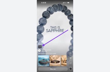 Screenshot of a YouTube Shorts ad for Mesmerize India featuring a sapphire beaded bracelet with "THIS IS SAPPHIRE" text and an AI label indicator pointing to the sponsored content.