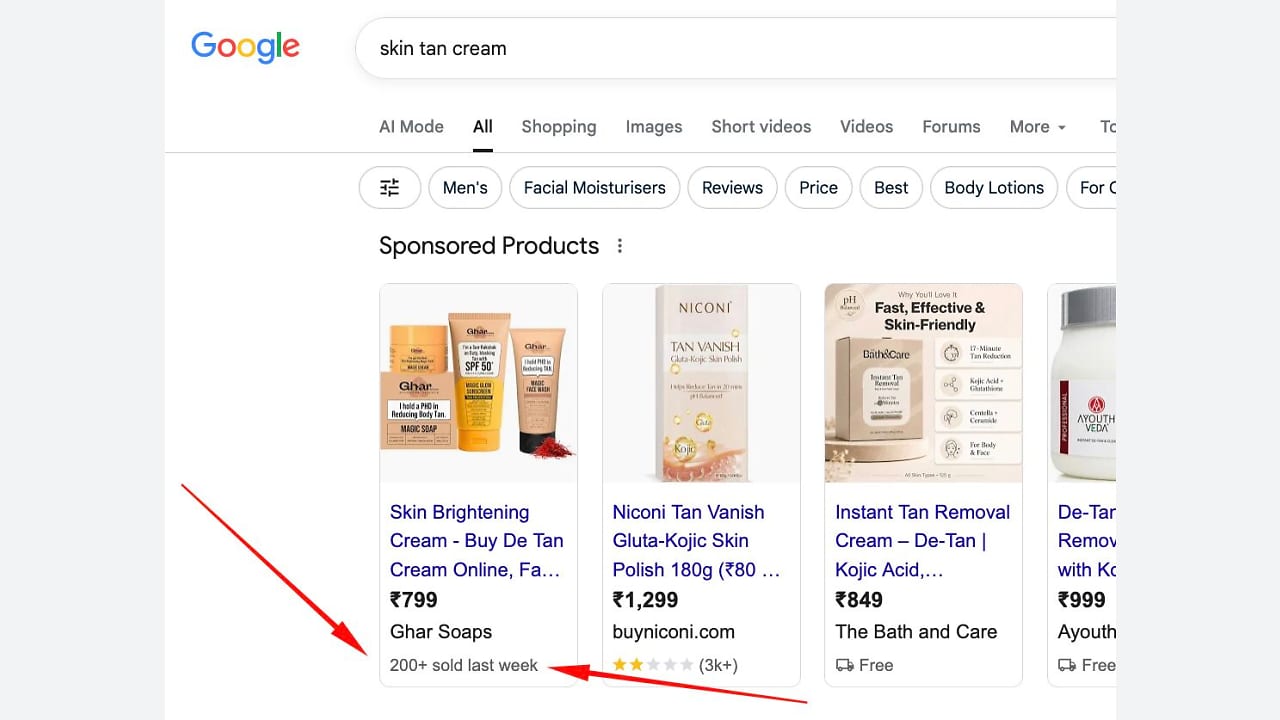 Screenshot of Google search results for “skin tan cream,” showing sponsored product listings with prices, ratings, and product images. A red arrow points to “200+ sold last week” under the first product listing.