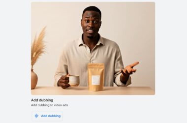 Man demonstrating a product in a video ad with a kraft paper package and white mug on a table, with decorative pampas grass in a vase in the background