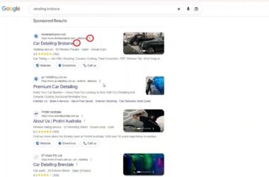 Google search results page showing sponsored listings for car detailing services in Brisbane with pop-up information indicators marked by red circles on the ads