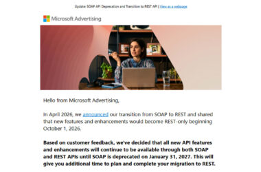 A woman working at a desk with a laptop, shelving, and office plants in the background, representing Microsoft Advertising's announcement about API transition from SOAP to REST.